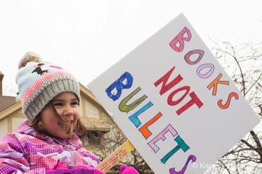Girl holding sign Books not Bullets